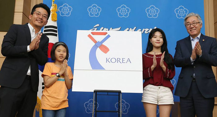 23일 김종덕 문화체육관광부장관(오른쪽)이 우수문화상품에 부착할 인증마크의 새로운 디자인을 공개했다. 오른쪽에서 두 번째는 인증마크를 디자인 한 최진아씨.