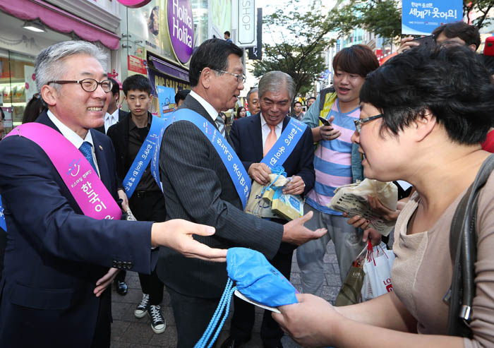 김종덕 문화체육관광부 장관이 가두캠페인 중 외국인 관광객에게 홍보물을 선물하고 있다.