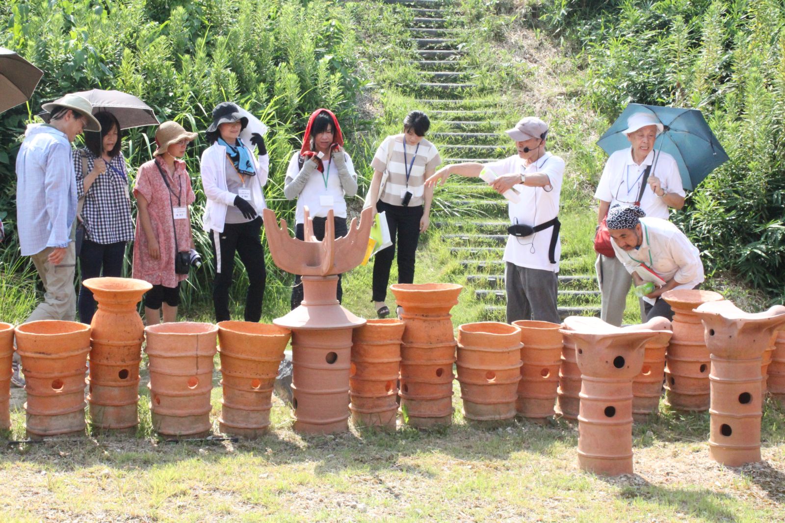 일본 교직원들이 한일 교류 흔적을 돌아보는 현장 답사 도중 이노쿠마 가네가츠 오사카왔소문화교류협회 이사장의 설명을 들으며 이와세천총고분군 출토물을 살펴보고 있다.